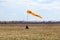 Horizontally flying windsock wind vane with red and yellow lines