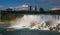 The Hornblower cruise boat traveling under a rainbow in front of the American Falls