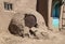 Horno - mud adobe outdoor oven in Southwestern US Pueblo community with old metal barrel top protecting the opening - common in al