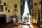 Horovice castle interior, Baroque chateau, carved wooden gilded furniture, Tea room, table and armchairs, porcelain set, cupboard