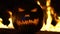 Horrible symbol of Halloween - Jack-o-lantern. Scary head of pumpkin in hell fire flames. Orange gourd in the center of