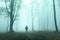 Horror dark man in silhouette in spooky foggy forest