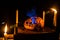 Horror Halloween concept. Close up view of scary dead Halloween pumpkin glowing at dark background. Rotten pumpkin head