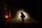 Horror scene of a scary children\'s ghost, Silhouette of scary baby doll on dark foggy background with light