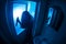 Horror silhouette of woman in window. Scary halloween concept Blurred silhouette of witch in bathroom. Selective focus