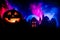 Horror view of Halloween pumpkin with scary smiling face. Head jack lantern with spooky building