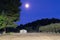 Horse arena against full moon.