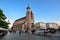 Horse carriage at main square in Krakow in a summer day, Poland. Two Horses In Old-fashioned Coach in front of St. Mary`s Basilic