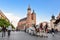 Horse carriage at main square in Krakow in a summer day, Poland. Two Horses In Old-fashioned Coach in front of St. Mary`s Basilic