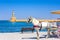 Horse carriages and lighthouse at the old harbor of Chania, Crete.