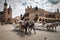 Horse carriages at the main square Rynek Glowny in Krakow old town