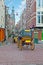 Horse carts through the narrow streets in Amsterdam Netherlands