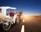 horse and classic fairy tale carriage on asphalt road perspective to beautiful land scape with sun rising sky