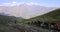 Horse convoy carrying luggage on Caucasus mountain path in Stepantsminda