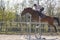 Horse cross country teenage competition jumping tree trunks and jumps over barrels of water and colored bars