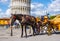 Horse drawn cab at the Leaning Tower of Pisa - a tourist attraction - PISA ITALY - SEPTEMBER 13, 2017