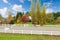 Horse farm with white fence and fall colorful leaves.