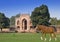 horse on a grass before Gate to Itmad-Ud-Daulah\'s Tomb at Agra, Uttar Pradesh, India