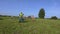 Horse handler with wheelbarrow on hurdle field