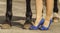 Horse hoof feet near the feet of woman shoes