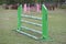 Horse obstacle course outdoors summertime. Poles in the sand at equestrian center outdoors