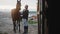 Horse Owner With Her Brown Horse Outside The Stable In The Sandy Ground