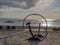 Horse passing under a wooden arch as it gallops along the beach of Ayia Eirini