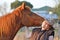 Horse & pretty young lady sharing kisses & laughs