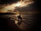 Horse rider on beach at sunset