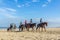 horse riders on the beach on beautiful sunny day