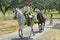 Horse riding, rural landscape, traditional costume