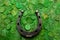 Horse shoe on green clovers background. St. Patrick`s day