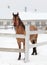 Horse in snow outside farm corral