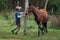 Horse trainer spinning fast in circles with a mare