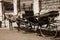 Horse and vintage coach waiting the passengers close to fence