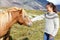 Horse - woman petting Icelandic horses in sweater