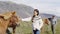 Horse - woman petting Icelandic horses in sweater on Iceland.