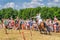 Horseback archery show with flying arrow to the target