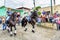 Horseback cowboy & cowgirl ride in village, Guatemala