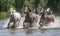 Horseback riders splashing through river Creating using generative AI tools