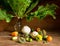 Horseradish in a vase and various fresh vegetables on wooden background