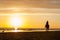 Horseriding at the beach on sunset background. Multicolored outdoors image.