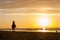 Horseriding at the beach on sunset background. Multicolored outdoors image.