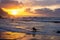 Horseriding at ocean beach on sunset background