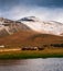 Horses from a farm in southern Iceland at the foot of snowy mountain