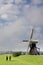 Horses in front of a windmill