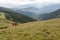 Horses grazed on a mountain pasture against mountains