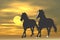 Horses running at sunrise