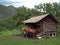 Horses are tied near a wooden hunting Lodge in the forest for tourists on a hike in the mountains in the summer