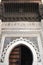 Horseshoe Arch decorated with Arabic Mosaic and Moroccan Arabesque Carvings at the Medieval Medina of Fes al Bali